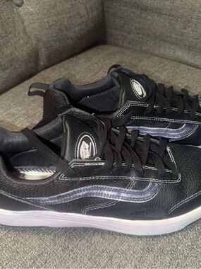 Vans Black Low-Top Sneakers with white stitching accents